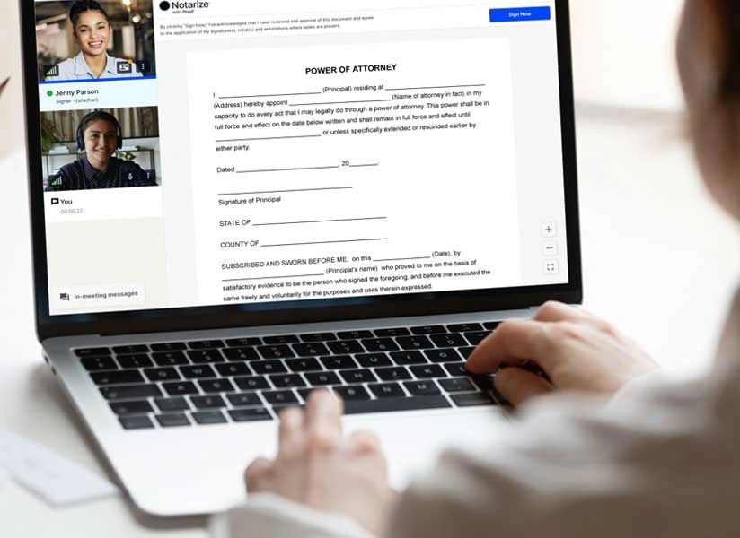 Person participating in a virtual notarization of a power of attorney document on a laptop.