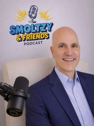 Smoltzy & Friends podcast host smiling with microphone.
