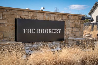 Sign reading 'THE ROOKERY' on a stone wall.
