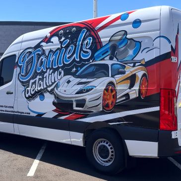 Van with colorful car detailing advertisement.