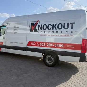 Knockout Plumbing service van with contact info.