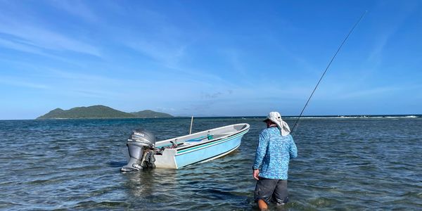 Perry walking the flats in Roatan searching for tailing bonefish and permit on the fly!
