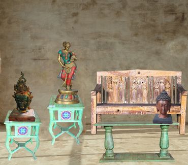 The eclectic mix of antique church bench, jade console, end tables, buddha, tara and shukasarika!