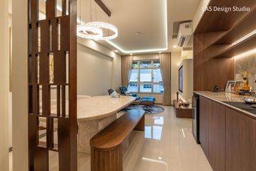 Modern kitchen and dining area with warm wood finishes and elegant lighting.