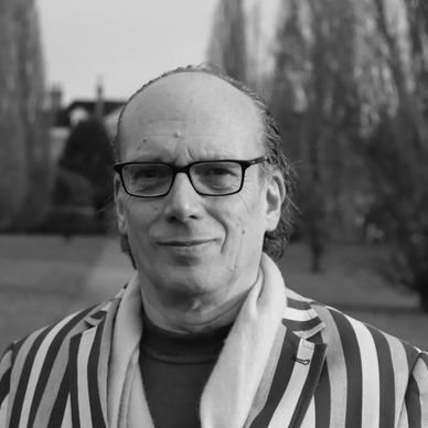 Marc Jarrett is featured from England wearing black glass and a striped suit coat.