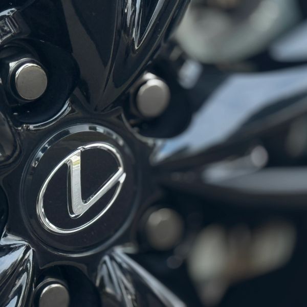Close-up of a Lexus car wheel with the logo prominently displayed.
