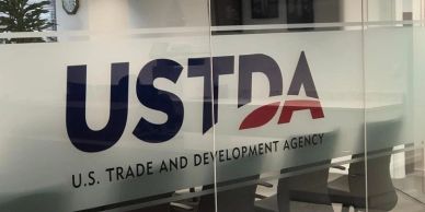 USTDA logo on a glass door.