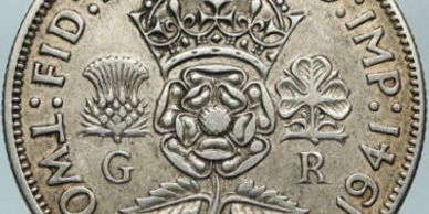 Close-up of 1941 British coin with floral emblem.