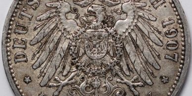 Close-up of a 1907 German coin with an eagle emblem.