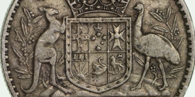 Close-up of a coin showing Australian animals and a coat of arms.