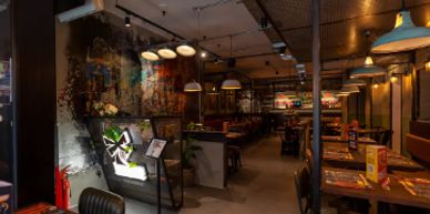Cozy, dimly lit restaurant interior with modern decor and ambient lighting.
