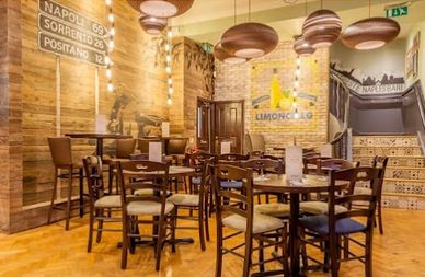 Cozy Italian restaurant with wooden decor and warm lighting.