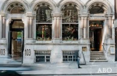 Historic building facade with arched windows and the number 103.