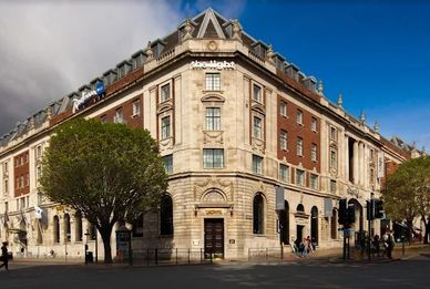 Historic building with a blend of classical and modern architecture on a sunny day.