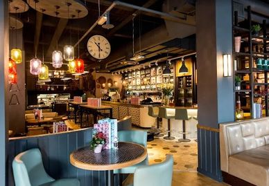 Cozy, modern cafe interior with warm lighting and stylish seating.