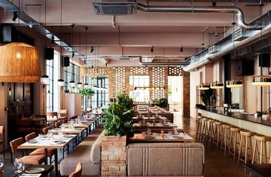 Stylish modern restaurant interior with warm lighting and wooden furniture.