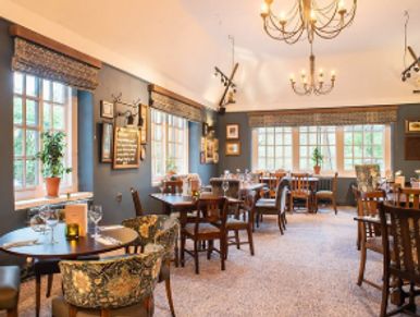 Cozy restaurant interior with wooden furniture and warm lighting.