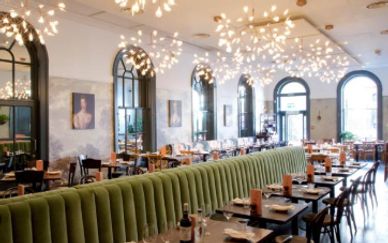 Elegant restaurant interior with large windows and unique lighting.