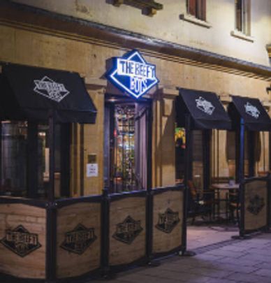 Entrance of The Beef Eaters pub at night.