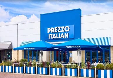 Prezzo Italian restaurant storefront with outdoor seating.