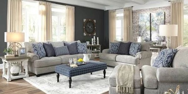 Cozy living room with beige sofas and blue accents.
