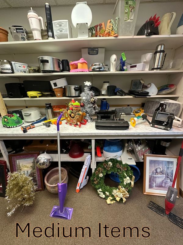 A shelf with medium-sized household items and decorations.