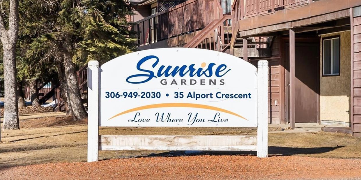 Sign for Sunrise Gardens with contact and address