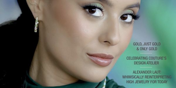 Close-up of a woman showcasing elegant jewelry and makeup.
