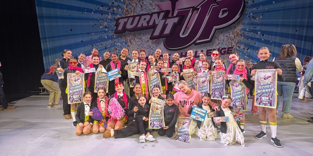 Large group of young dancers celebrating with awards at Turn It Up challenge.