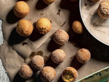 Winter Squash Doughnut Holes with a bowl of cinnamon sugar.