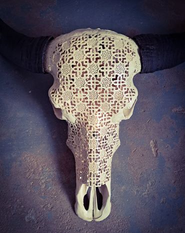 Ornamental carved water buffalo skull with striking black horns

