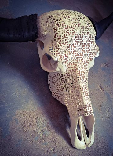 Ornate carved water buffalo skull with dark horns