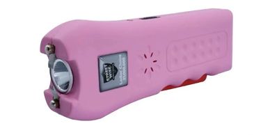 Pink handheld stun gun with metal prongs and textured grip.