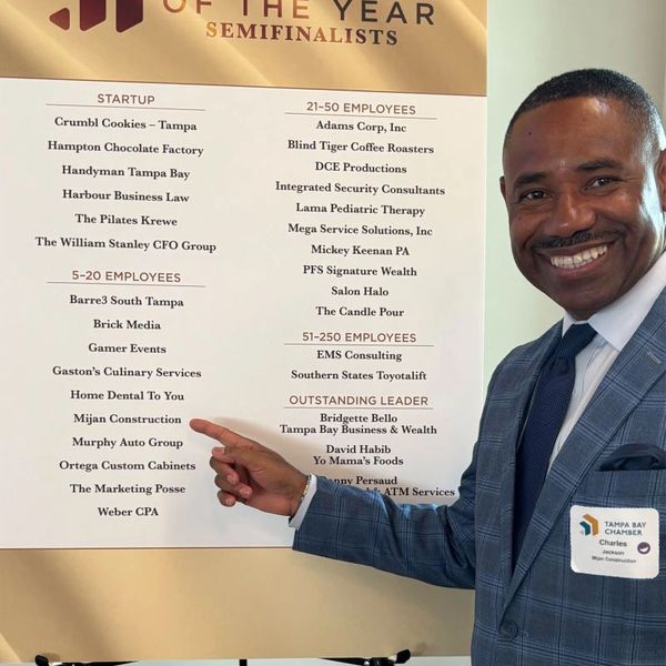 Man points at a business semifinalists list.