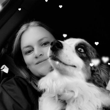 Woman smiling with her dog, surrounded by heart effects in black and white.