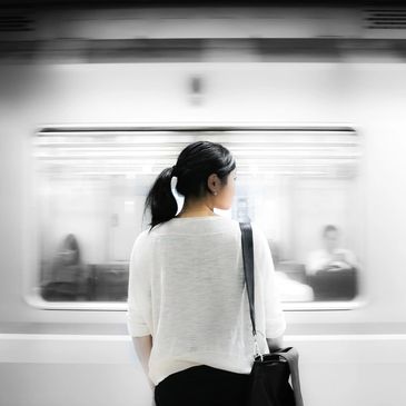 Woman standing by passing train