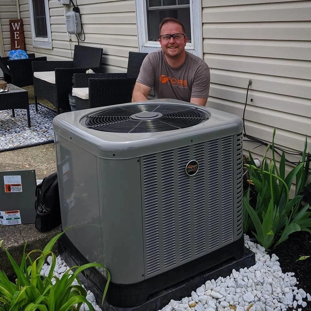 Owner and Founder of Fore Building Solutions with an Air Conditioner 