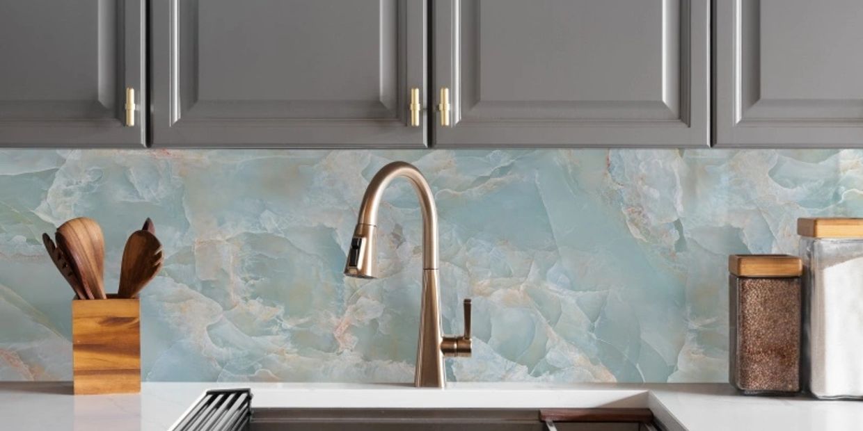 Modern kitchen sink with blue marble backsplash.