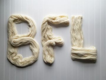 The letters BFL spelled out in yarn