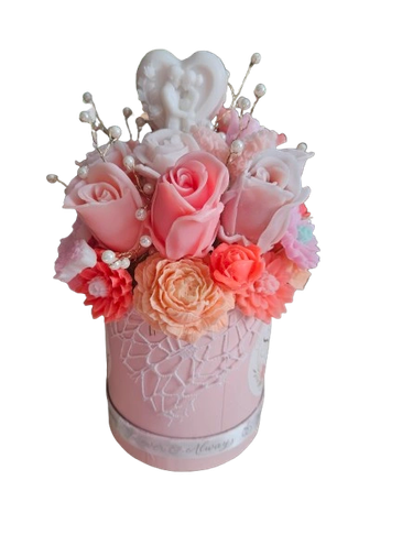 Elegant pink floral arrangement in a decorative vase.