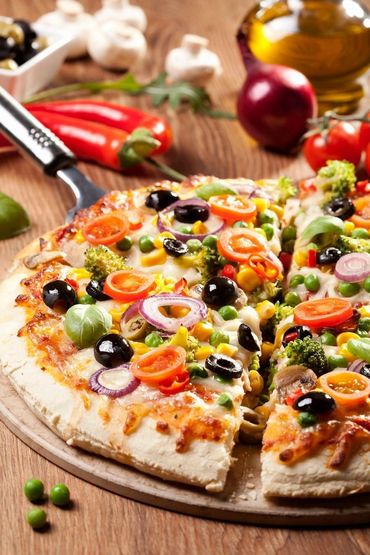 Vegetarian pizza on a plate with ingredients 