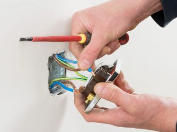 Electrician repairing socket