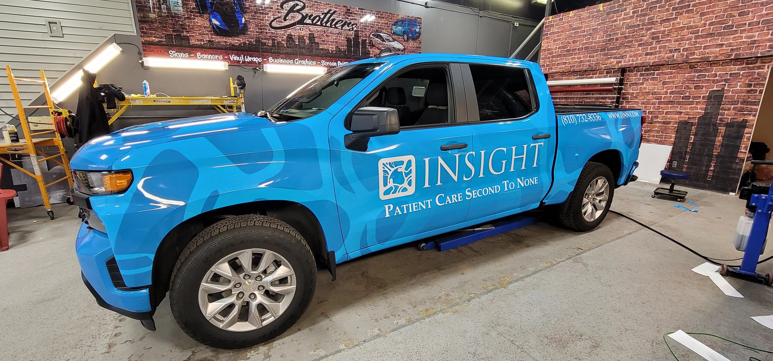 Blue pickup truck with Insight patient care branding.