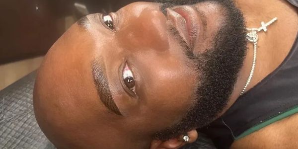 Handsome black man with beard and sexy brow lamination eyebrows staring at you. lgbt  makeup studio