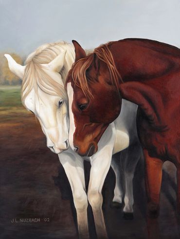 A white horse and a chestnut horse in a pasture nuzzling each other.