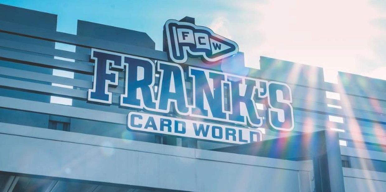 Signboard of Frank's Card World with sun glare.