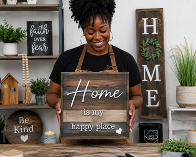 Woman holding a wooden sign that says 'Home is my happy place.'