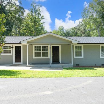 Gray house with black doors and white trim.