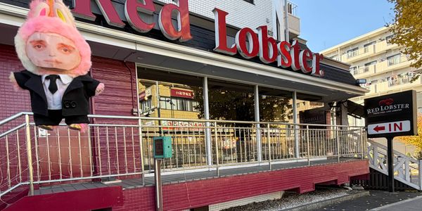 A Red Lobster restaurant exterior with a unique plush figure in front.