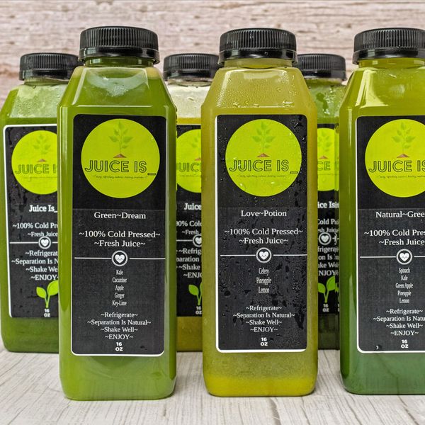 Bottles of cold-pressed fresh green juices labeled with different flavors.